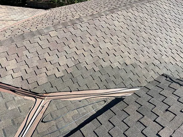 Asphalt shingle roof surface inspected for hail bruising and granule loss in Salt Lake City, UT