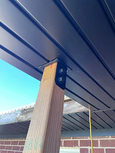 New trim and soffit panels finishing the roof edge over a porch in Salt Lake City, UT